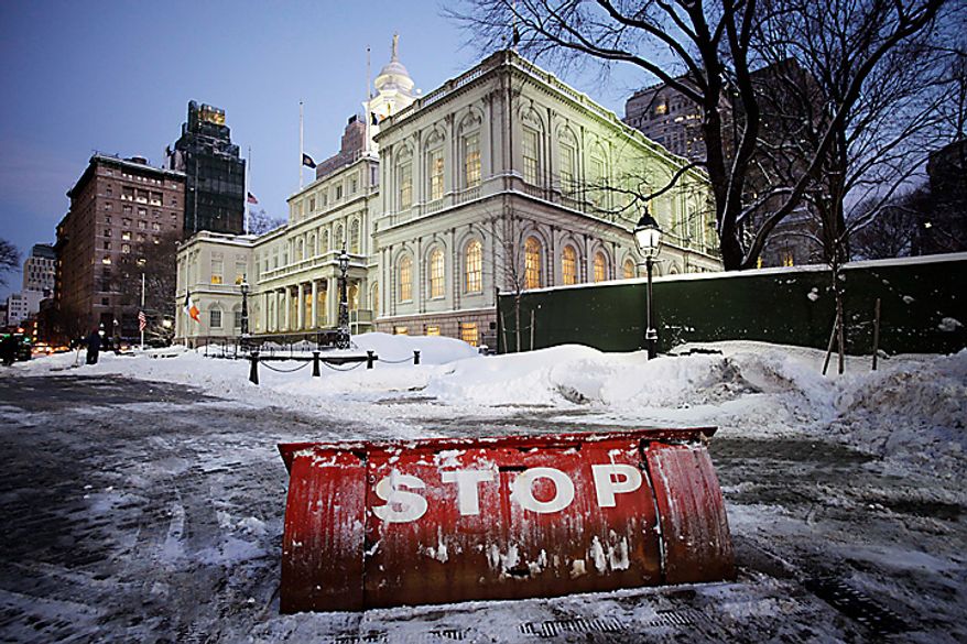 The street in front of New York's City Hall is clear after a snow storm, Wednesday, Jan. 12, 2011. "Stop" is written on a security barricade. Armies of plows and salt spreaders hit the streets up and down the East Coast to stem chaos during Wednesday morning's commute as a storm that shut down much of the South churned northward and dumped several inches of wet, heavy snow on areas already weary of winter. (AP Photo/Mark Lennihan)