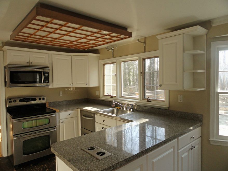 The centrally located kitchen was renovated in the last five years. It has white cabinets and stainless steel appliances.