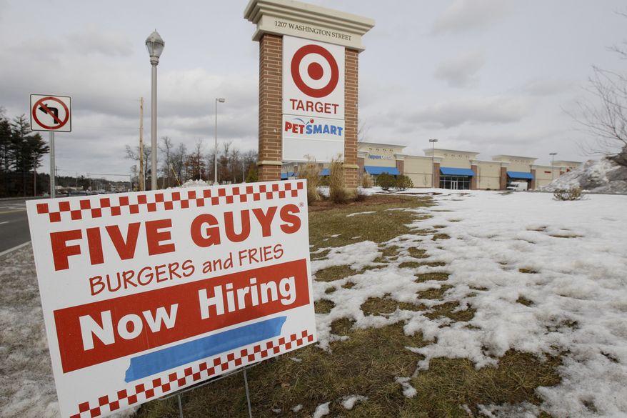 A Five Guys hamburger restaurant under construction advertises job openings on Friday, Jan. 7, 2011. More people applied for unemployment benefits in the week ending Jan. 8 after retailers shed temporary holiday employees. (AP Photo/Stephan Savoia)