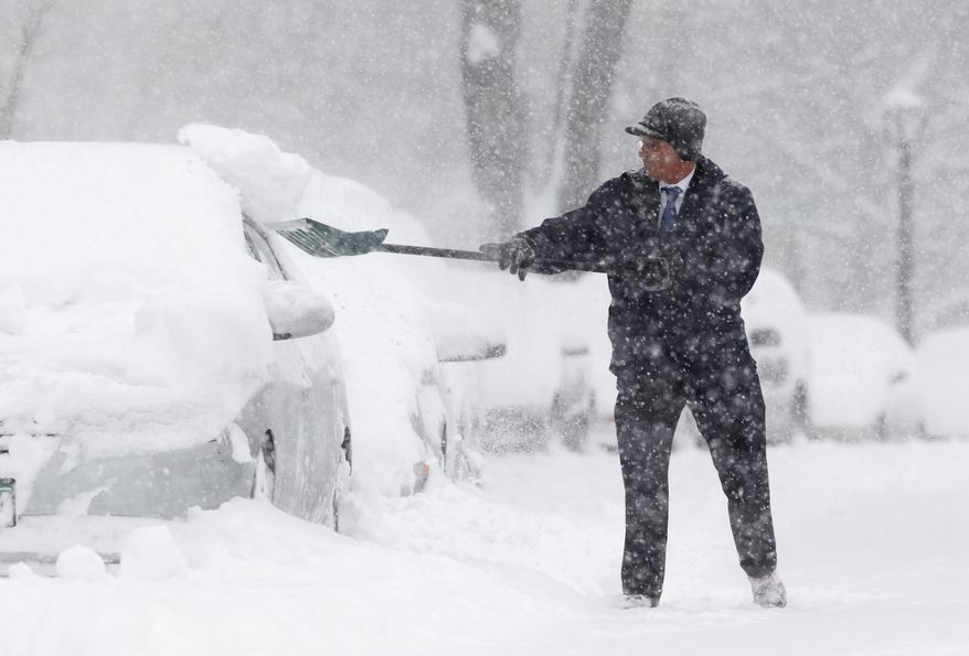 Jim Schumacher shovels snow near his vehicle in Albany, N.Y., on Wednesday, Jan. 12, 2011. (AP Photo/Mike Groll)
