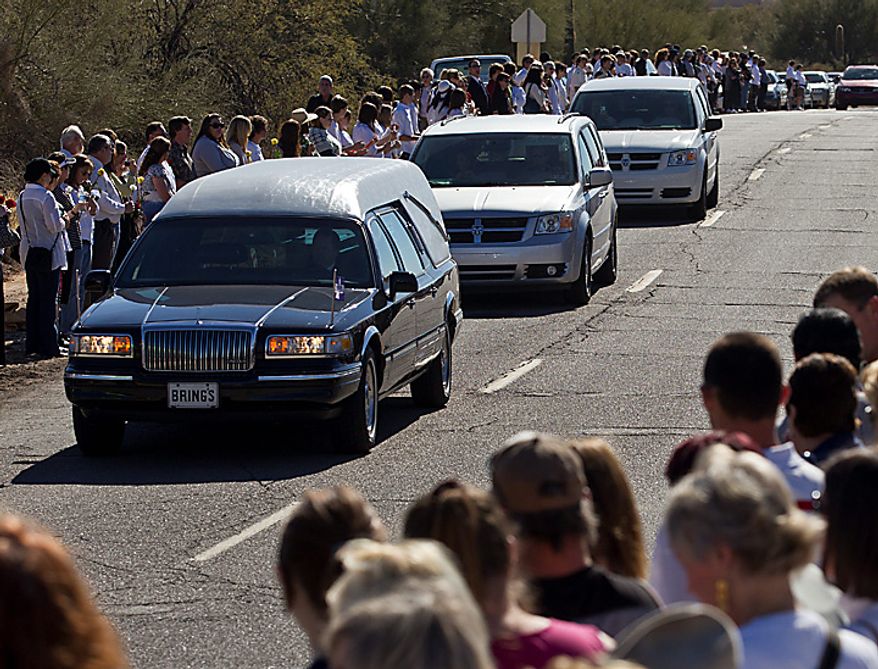 A hearse arrives at the St. Elizabeth Ann Seton Church for the funeral of 9-year-old Christina Green Thursday, Jan. 13, 2011, in Tucson, Ariz. Green was the youngest victim of Saturday's shooting in Tucson. (AP Photo/Chris Carlson)