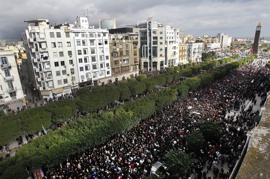 Protesters chant slogans against President Zine El Abidine Ben Ali during a demonstration in Tunis, Friday, Jan. 14, 2011. Thousands of angry demonstrators marched through Tunisia's capital Friday, demanding the resignation of the country's autocratic leader a day after he appeared on TV to try to stop deadly riots that have swept the North African nation. (AP Photo/Christophe Ena)