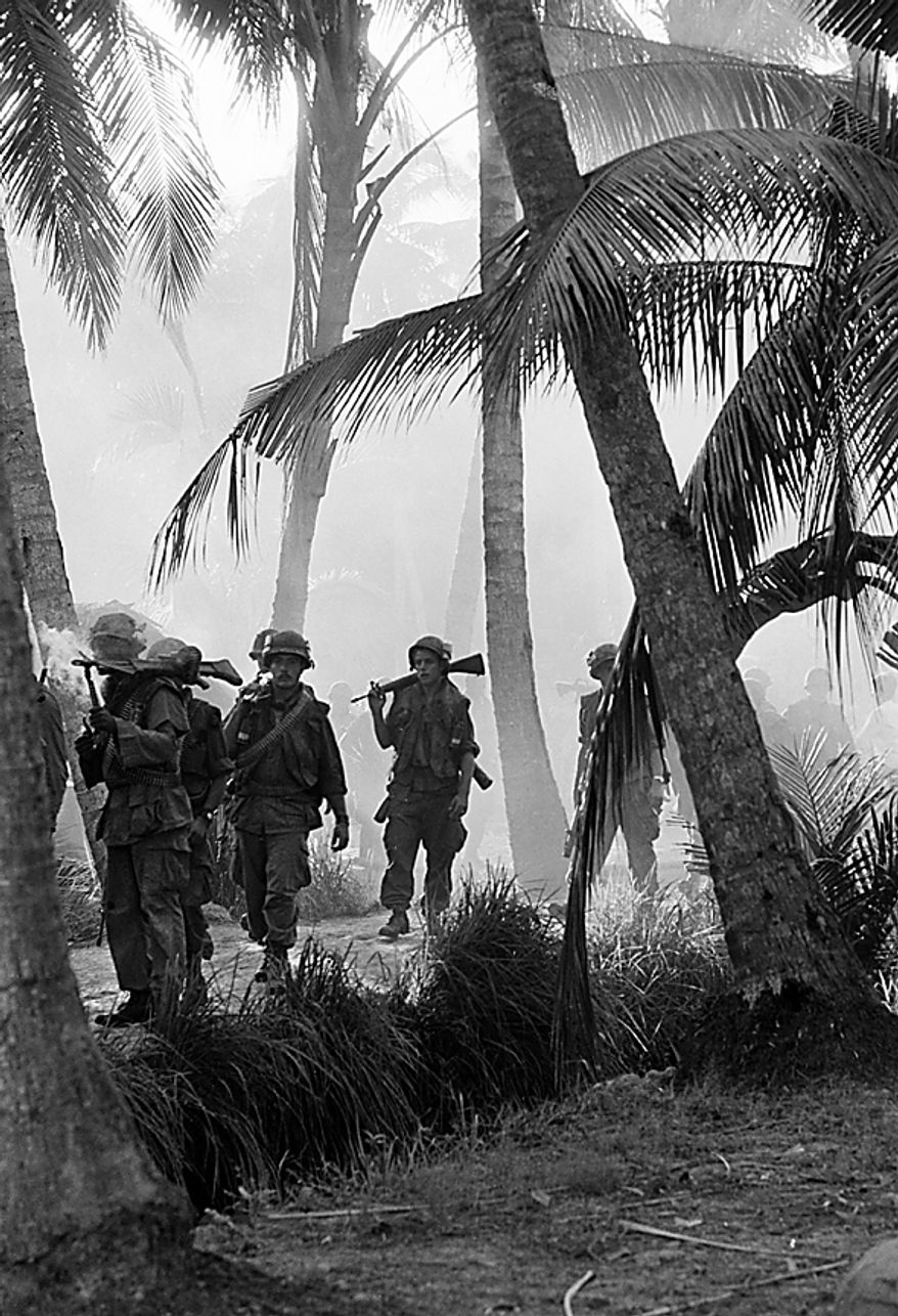 A U.S. patrol of the 2nd Brigade, 9th Infantry Division, moves through the morning mist in the coconut groves of Kien Hoa province, in South Vietnam's Mekong Delta, Jan. 15, 1969. They were part of an operation to assess damage from a B-52 strike on Viet Cong strongholds in the province. (AP Photo/Henri Huet)