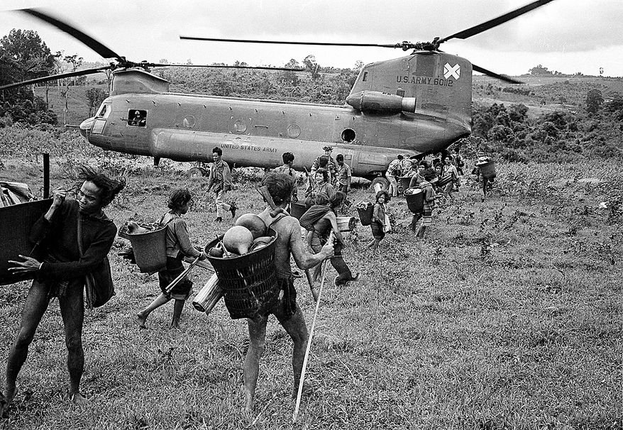 Members of the Montagnard tribe are transported by U.S. Army helicopters to a nearby refugee camp from the village of Bu Lach, 60 miles northeast of Saigon, Sept. 1968. The groups, some 700 in all, asked the South Vietnamese government for help in moving to a more secure area during fighting in the Vietnam War. (AP Photo/Henri Huet)