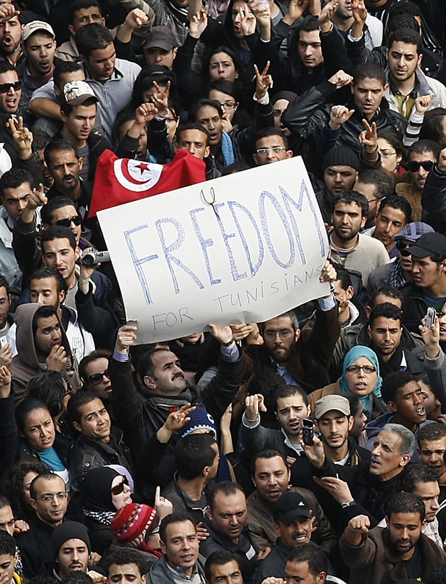Protesters chant slogans against President Zine El Abidine Ben Ali in Tunis, Friday, Jan. 14, 2011. Demonstrators marched through the Tunisian capital Friday, demanding the resignation of the country's autocratic leader a day after he appeared on TV to try to stop deadly riots that have swept the North African nation. (AP Photo/Christophe Ena)