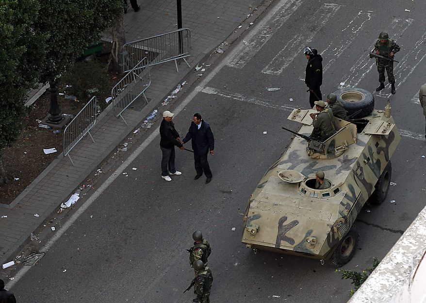 An armored vehicle patrols a street in Tunis during clashes, Friday, Jan. 14, 2011. Tunisia's president declared a state of emergency and announced that he would fire his government as violent protests escalated Friday, with gunfire echoing in the North African country's usually calm capital and police lobbing tear gas at protesters. (AP Photo/Christophe Ena)