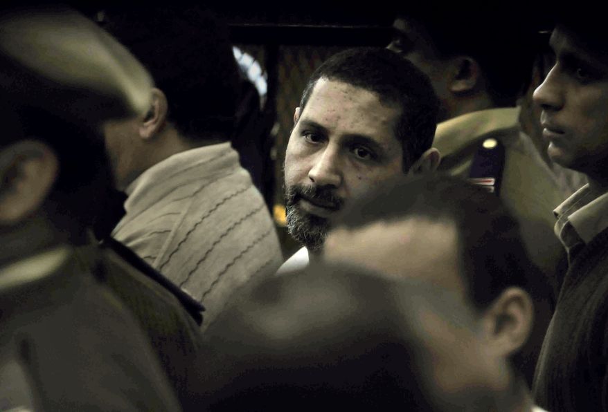 ** FILE ** Mohammed Ahmed Hassanein, also known by the alias Hammam al-Kamouni, who was one of three suspects charged in a Coptic Christmas Eve drive-by shooting on Jan. 6, 2010, in the southern Egyptian town of Nag Hamadi that killed seven people, looks on during his trial in Qena, Egypt, on Saturday, Feb. 13, 2010. The court on Sunday, Jan. 16, 2011, convicted and sentenced to death al-Kamouni for his part in the shooting, judicial officials said. (AP Photo/Mohammed Ahmed, File)