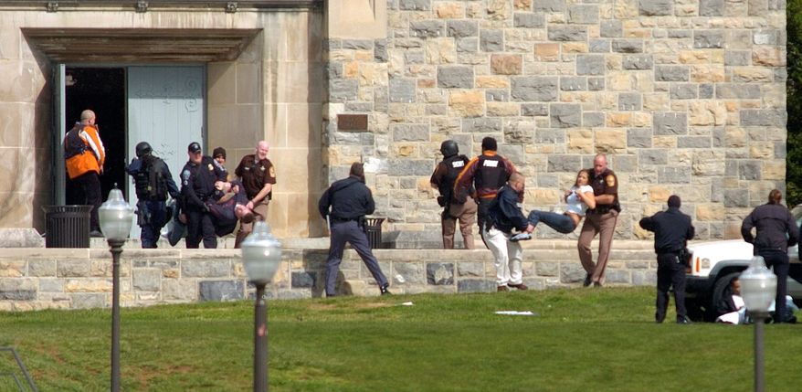 ** FILE ** Victims of the April 2007 massacre at Virginia Tech are carried out of Norris Hall. The mass shooting caused many colleges to reassess security measures, but dealing with troubled students remains a difficult issue. (AP Photo)