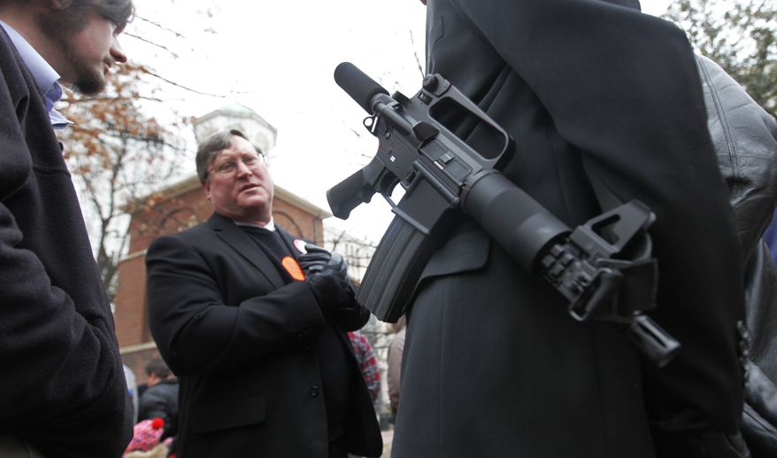 ** FILE ** Gun enthusiast D.J. Dorer of Yorktown, Va., carries his AR15 pistol outside the Capitol during a pro gun rally at the Capitol in Richmond, Va., Monday, Jan. 17, 2011. Speakers at Monday's event said tragedies such as the shooting spree in Arizona that wounded U.S. Rep. Gabrielle Giffords are no excuse for "destroying the Constitution." Instead, they called on lawmaker to relax Virginia's gun laws. (AP Photo/Steve Helber)