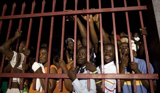 Supporters of Mr. Duvalier wait outside the terminal of the Toussaint Louverture international airport, after listening to radio reports of his return to Port-au-Prince. &quot;I&#x27;m not here for politics,&quot; Mr. Duvalier told Radio Caraibes. &quot;I&#x27;m here for the reconstruction of Haiti.&quot; (Associated Press)
