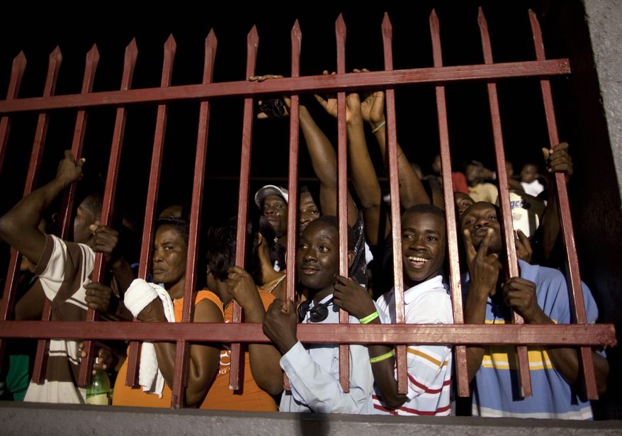 Supporters of Mr. Duvalier wait outside the terminal of the Toussaint Louverture international airport, after listening to radio reports of his return to Port-au-Prince. &quot;I&#x27;m not here for politics,&quot; Mr. Duvalier told Radio Caraibes. &quot;I&#x27;m here for the reconstruction of Haiti.&quot; (Associated Press)