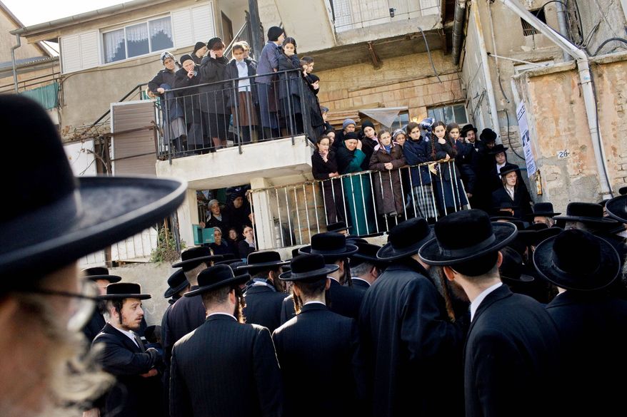 Ultra-Orthodox Jewish Satmar sect followers gather during the funeral of Rabbi Yeshayahu Deutsch in the religious neighborhood of Mea Shearim in Jerusalem on Thursday. Ultra-Orthodox Jews — known in Hebrew as "Haredim," or "those who tremble" before God — have a birthrate far higher than that of other Israeli Jews, with 10 children not uncommon, and they seem poised to become far more numerous and influential. (Associated Press)