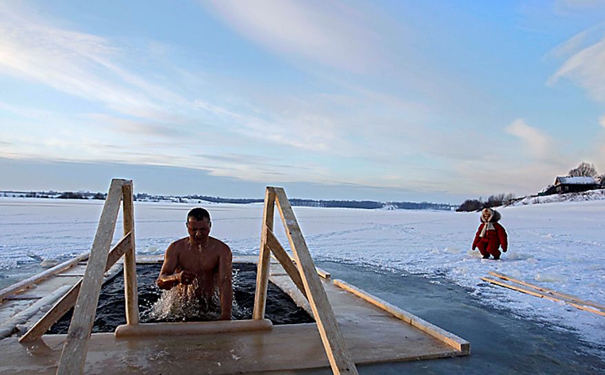A Russian man emerges from cold water on Epiphany in Uglich, Russia, some 250 kilometers (150 miles) northeast from Moscow, Wednesday, Jan. 19, 2011. Thousands of Russian Orthodox Church followers plunged into icy rivers and ponds across the country to mark Epiphany, cleansing themselves with water deemed holy for the day. Water that is blessed by a cleric on Epiphany is considered holy and pure until next year's celebration, and is believed to have special powers of protection and healing. (AP Photo/Sergey Ponomarev)