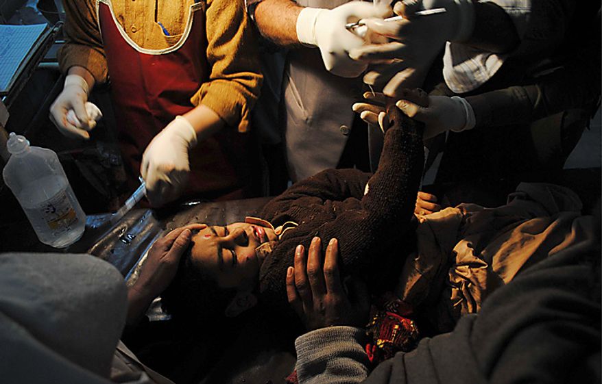 A student injured in a bomb explosion receives treatment at Lady Reading hospital in Peshawar, Pakistan, Wednesday, Jan. 19, 2011. The bomb exploded outside a school in a residential area of Peshawar city on Wednesday, killing at least one person and wounding 14 others. (AP Photo/Mohammad Iqbal)