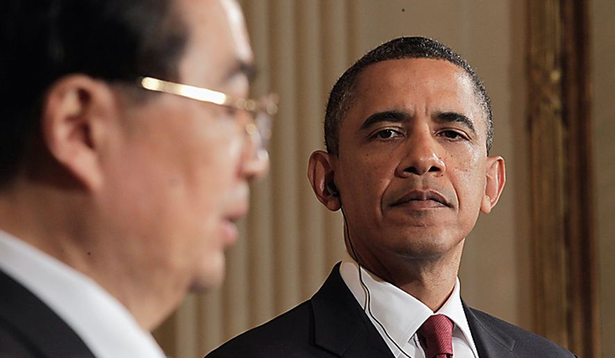 **FILE** President Obama looks on as Chinese President Hu Jintao speaks during a Jan. 19 news conference in the East Room of the White House. (Associated Press)