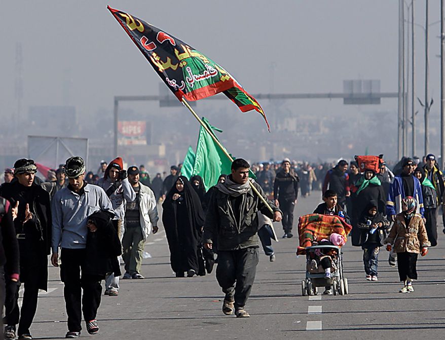 Shi'ite pilgrims march on their way to Karbala for Arbaeen, in Baghdad, Iraq, Thursday, Jan. 20, 2011. The holiday marks the end of the forty-day mourning period after the anniversary of the 7th century martyrdom of Imam Hussein, the Prophet Muhammad's grandson. (AP Photo/Khalid Mohammed)