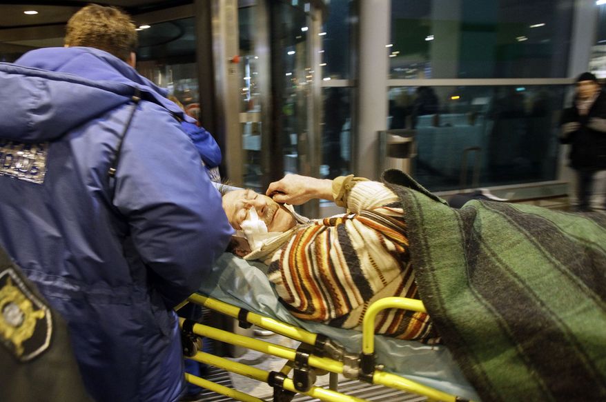 Rescuers carry away a man wounded in a blast at Domodedovo Airport in Moscow on Monday, Jan. 24, 2011. The explosion ripped through the international arrivals hall at the airport, the city's busiest, killing 31 people and wounding 170 others, officials said. Russian President Dmitry Medvedev called the bombing a terror attack. (AP Photo/Ivan Sekretarev)
