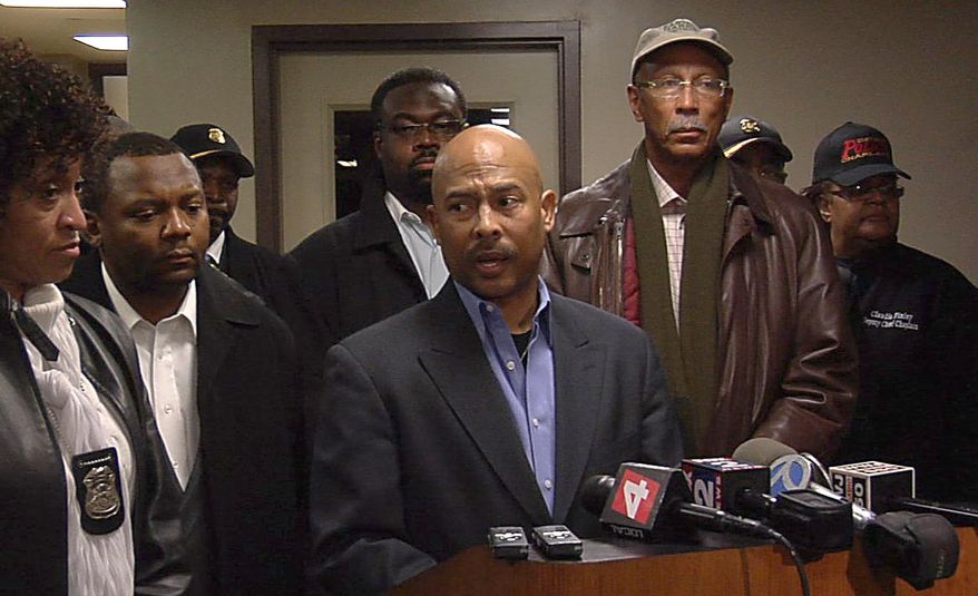 Detroit Police Chief Ralph Godbee (center) addresses the media at Sinai Grace Hospital, where police officers were taken after being shot by a gunman who walked into their precinct and opened fire. The gunman was killed after officers returned fire on Sunday, Jan. 23, 2011. Detroit Mayor Dave Bing (right) stands next to the police chief. (AP Photo/Detroit Free Press, Alexandra Bahou)