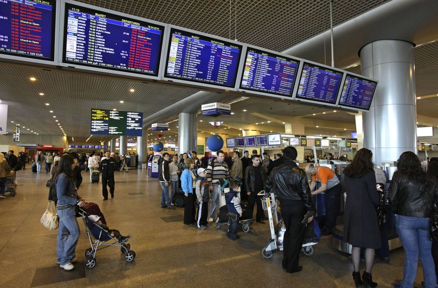 ** FILE ** Passengers check in for their flights at Domodedovo Airport outside Moscow in April 2010. An explosion on Monday, Jan. 24, 2011, ripped through the arrivals hall at the airport, the city's busiest, killing at least 31 and wounding 130 others, Health Ministry officials said. The state RIA Novosti said the explosion may have been caused by a suicide bomber. (AP Photo/Misha Japaridze)