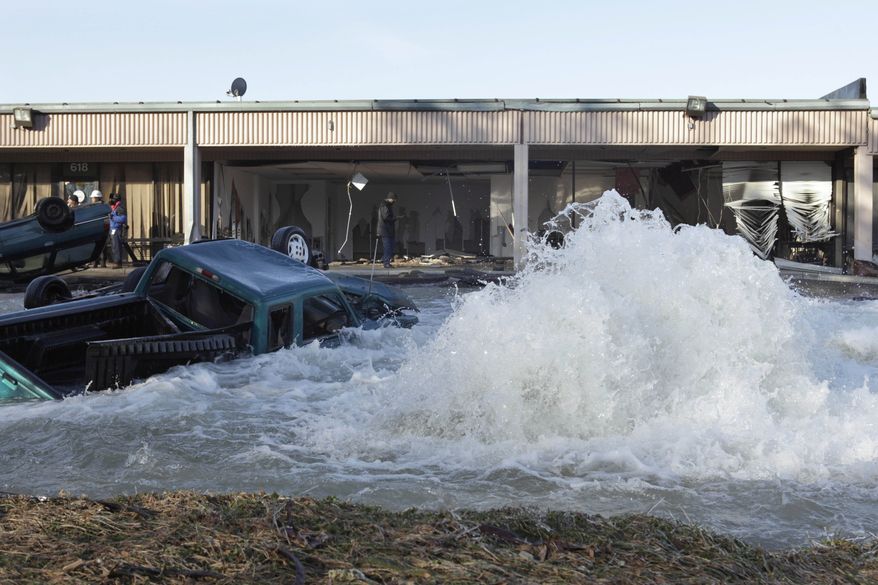 A water-main break at an industrial park next to the Capital Beltway in Capitol Heights, Md., on Monday, Jan. 24, 2011, sent water pouring from a 54-inch pipe and onto the highway, prompting the closure of the Inner Loop during the morning rush hour. (AP Photo/Jacquelyn Martin)