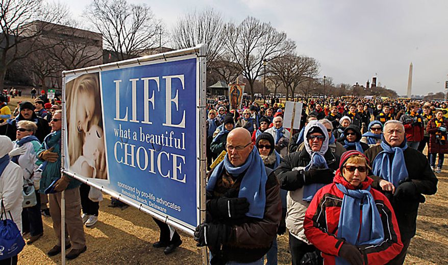 The national anthem is sung during an anti-abortion rally on the National Mall in Washington on Monday, Jan. 24, 2011. The anniversary of the Supreme Court's Roe v. Wade decision was Saturday. (AP Photo/Alex Brandon)