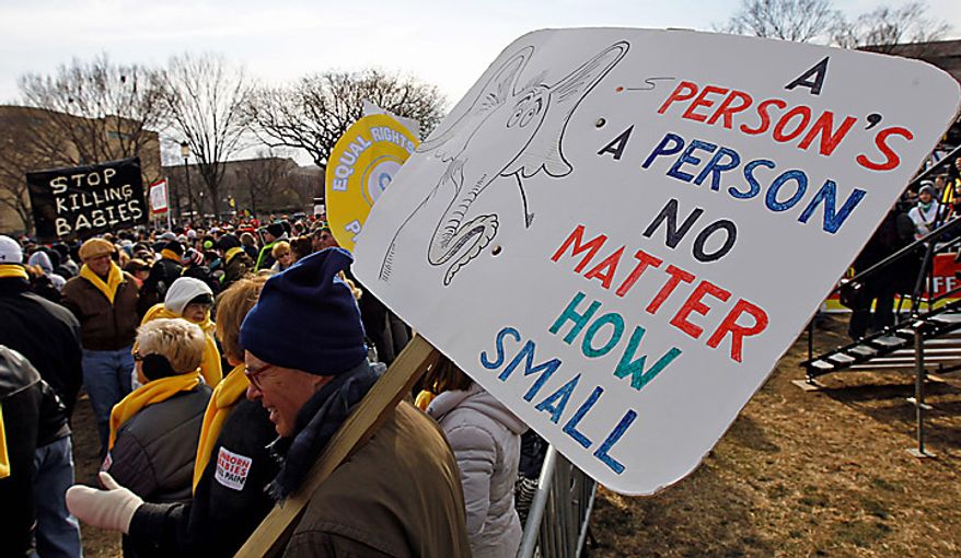Tom Sheahen of Deerpark, Md., holds a sign during an anti-abortion rally on the National Mall in Washington on Monday, Jan. 24, 2011. The anniversary of the Supreme Court's Roe v. Wade decision was Saturday. (AP Photo/Alex Brandon)