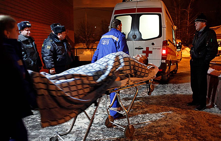 A wounded blast victim is wheeled in a hospital near Domodedovo Airport in Moscow, Monday, Jan. 24, 2011. A suicide bomber set off an explosion that ripped through Moscow's busiest airport on Monday, coating its international arrivals terminal in blood. The attack killed dozens of people and wounded more than a hundred. (AP Photo/Alexander Zemlianichenko)