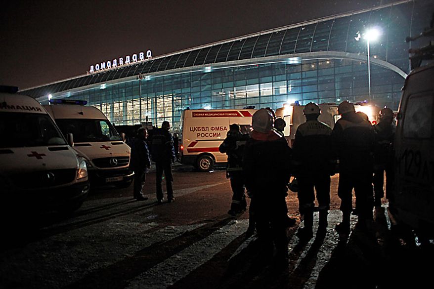 Ambulance vehicles and emergency workers are seen in front of Domodedovo Airport in Moscow, Monday, Jan. 24, 2011. An explosion ripped through the international arrivals hall at Moscow's busiest airport on Monday, killing dozens of people and wounding scores, officials said. Russian President Dmitry Medvedev called it a terror attack. (AP Photo/Alexander Zemlianichenko)