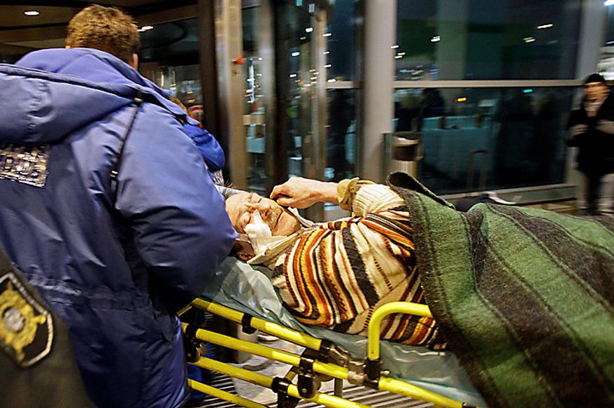 ** FILE ** A man wounded in a blast is carried away at Domodedovo Airport in Moscow on Monday, Jan. 24, 2011. An explosion ripped through the international arrivals hall at the city's busiest airport, killing dozens of people and wounding scores, officials said. Russian President Dmitry Medvedev called it a terror attack. (AP Photo/Ivan Sekretarev)