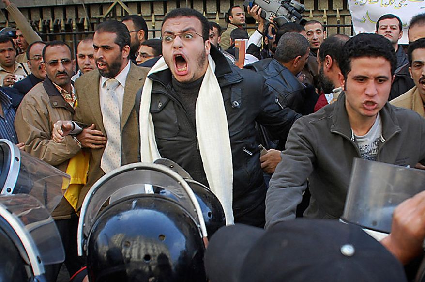 Protesters are confronted by riot police as they demonstrate in downtown Cairo, Egypt, Tuesday, Jan. 25, 2011. Hundreds of anti-government protesters marched in the Egyptian capital chanting against President Hosni Mubarak and calling for an end to poverty. (AP Photo/Mohammed Abu Zaid)