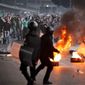 Egyptian riot police clash with anti-government activists in Cairo on Wednesday. The activists clashed with police for a second day Wednesday in defiance of an official ban on any protests. (Associated Press)