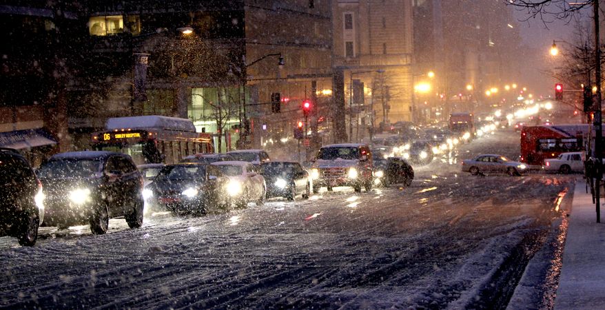 Vehicles clog the downtown streets of Washington as traffic comes to a halt as snow begins to fall, Wednesday, Jan. 26, 2011. (AP Photo/Pablo Monsivais)