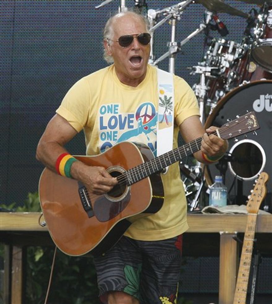 FILE - In this July 11, 2010 file photo, Jimmy Buffett performs in Gulf Shores, Ala. Buffett fell off a stage at the end of a concert in Sydney, Wednesday, Jan. 26, 2011, and was rushed to the hospital. Australia's Daily Telegraph reports that audience members saw the 64-year-old fall face first off the stage and hit his head. (AP Photo/Chip English, file)