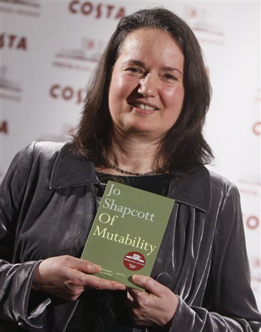 British author Jo Shapcott, the Costa Poetry Award winner and shortlisted for the Costa Book of the Year poses for the media holding her book ' Of Mutability ' at the awards ceremony in London,Tuesday, Jan. 25, 2011. (AP Photo/Alastair Grant)