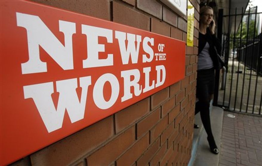 **FILE** This photo from July 9, 2009, shows a sign for the News of the World newspaper outside the offices of its owner News International Ltd., in London. (Associated Press)