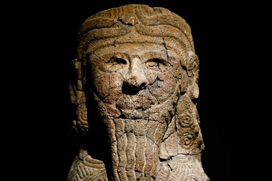 Fragments and a partial reconstructed sculpture are on display at the exhibition 'The Tell Halaf Adventure' at the Pergamon Museum in Berlin on Thursday, Jan. 27, 2011. The exhibition shows roughly 3,000-year old statues that have been pieced together over the past decade from fragments left behind when Berlin's Tell Halaf Museum was bombed in 1943. After the wartime bombing, the rubble was salvaged and stored for decades in the Pergamon Museum's cellars. Restorers sifted through some 27,000 fragments to restore the sculptures. (AP Photo/Markus Schreiber)