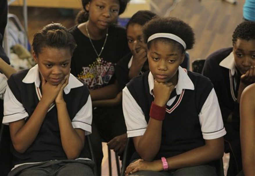Actresses Khomotso Manyaka, right, and Keaoboka Makanyane, left, watch the Oscar nominations on an internet feed with fellow pupils at the School of the Arts in Johannesburg, Tuesday Jan. 25, 2011. The two are proud to been part of a film with an important lesson about AIDS in a country where teens like themselves carry heavy burdens because of the disease. The film almost made it to the Oscars with "Life, above all." It had been among nine possible best foreign language film nominees, but did not make the final cut when the Oscar five were announced. (AP Photo/Denis Farrell)