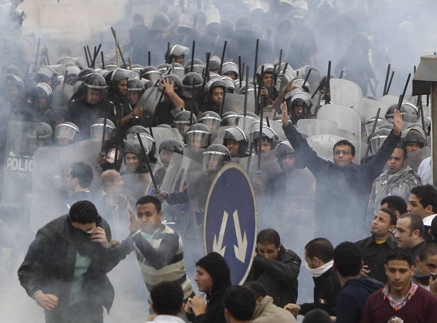 Egyptian anti-government activists clash with riot police in Cairo Friday, Jan. 28, 2011. Tens of thousands of anti-government protesters poured into the streets of Egypt Friday, stoning and confronting police who fired back with rubber bullets and tear gas in the most violent and chaotic scenes yet in the challenge to President Hosni Mubarak's 30-year rule. One protester was killed and even a Nobel Peace laureate was placed under house arrest after joining demonstrations. (AP Photo/Ben Curtis)
