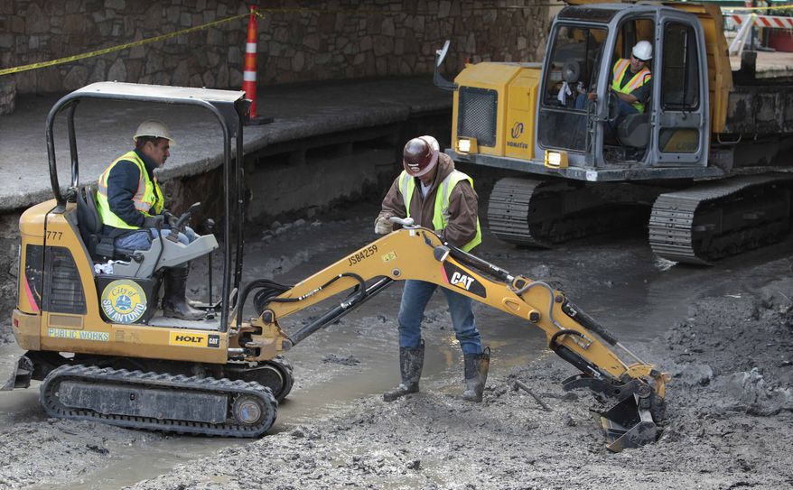 ** FILE ** Workers work along the San Antonio River Walk after the river was drained to clean out silt and muck and make repairs on Friday, Jan. 7, 2011, in San Antonio. (AP Photo/Eric Gay)