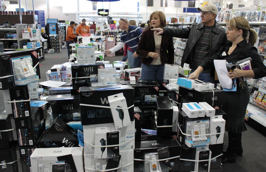 **FILE** Shoppers browse Nov. 26 at an electronics store in Albuquerque, N.M. The economy gained strength at the end of last year as Americans spent at the fastest pace in four years and U.S. companies sold more overseas. The growth is boosting hopes for a stronger 2011. The Commerce Department reported Friday that growth rose to an annual rate of 3.2 percent in the October-December quarter. (Associated Press)