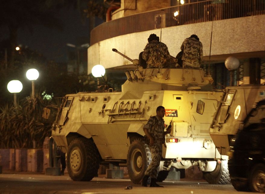 Egyptian army armored vehicle are seen outside the television building following protests in Cairo Friday, Jan. 28, 2011. The Egyptian capital Cairo was the scene of violent chaos Friday, when tens of thousands of anti-government protesters stoned and confronted police, who fired back with rubber bullets, tear gas and water cannons. It was a major escalation in what was already the biggest challenge to authoritarian President Hosni Mubarak's 30 year-rule. (AP Photo/Victoria Hazou)