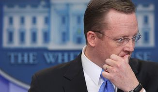 ** FILE ** Then-White House press secretary Robert Gibbs listens to a question on Egypt during his daily news briefing in the White House in Washington on Friday, Jan. 28, 2011. (AP Photo/Carolyn Kaster)