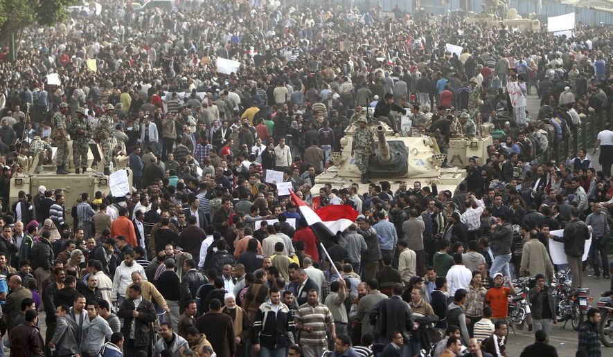 Thousands of Egyptians surround army tanks in downtown Cairo, Egypt, on Saturday, Jan. 29, 2011. Hundreds of anti-government protesters have returned to Cairo&#39;s central Tahrir Square, chanting slogans against Hosni Mubarak . (AP Photo/Ahmed Ali)