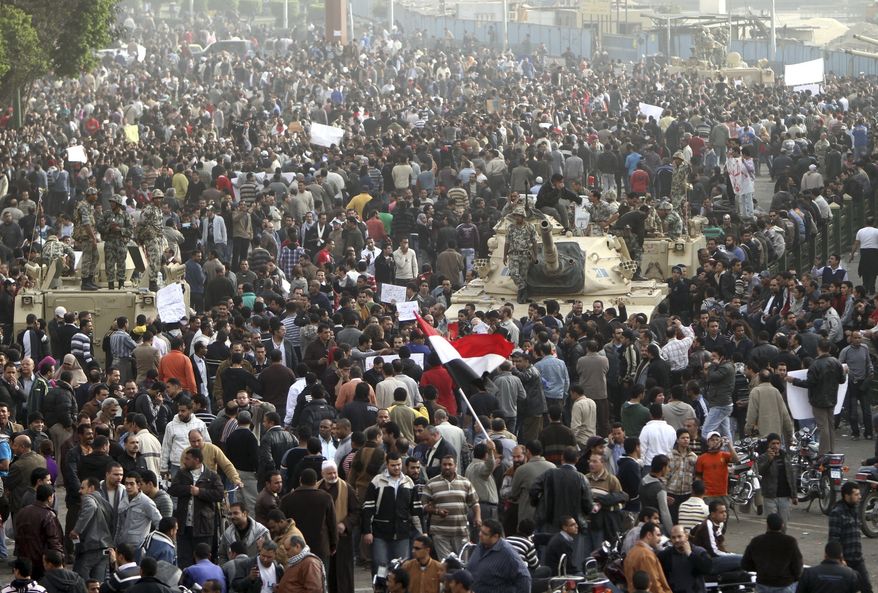 Thousands of Egyptians surround army tanks in downtown Cairo, Egypt, on Saturday, Jan. 29, 2011. Hundreds of anti-government protesters have returned to Cairo&#x27;s central Tahrir Square, chanting slogans against Hosni Mubarak . (AP Photo/Ahmed Ali)