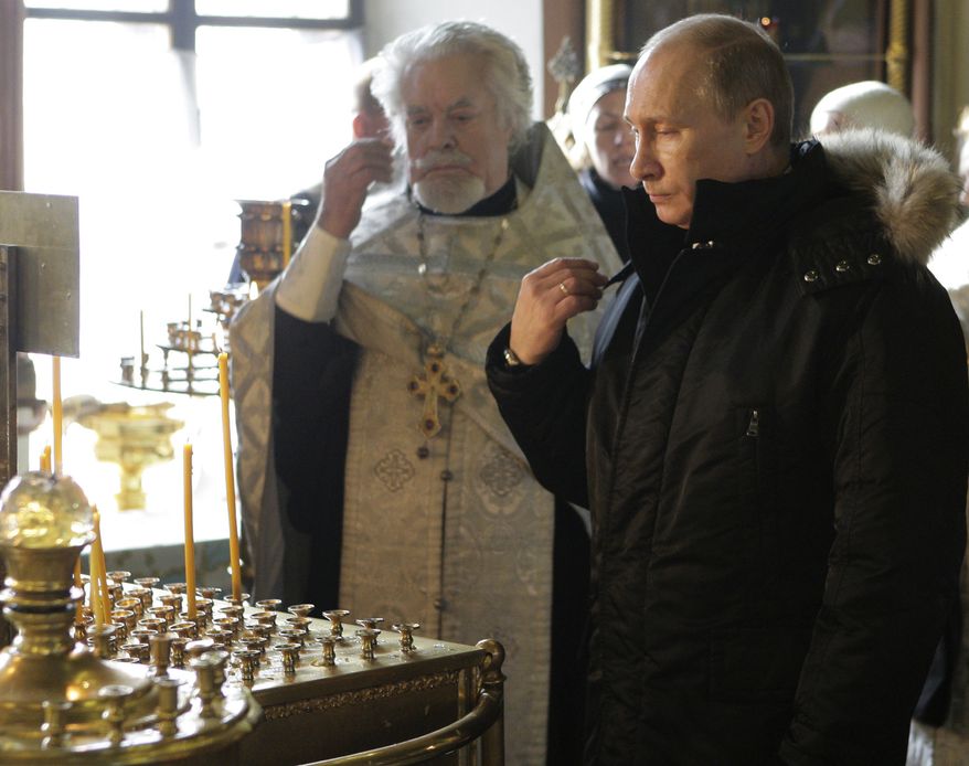Russian Prime Minister Vladimir Putin attends a religious service in a church in Moscow on Wednesday, Jan. 26, 2011, for the Domodedovo airport blast victims. A suicide bomber set off an explosion that ripped through Moscow's busiest airport on Monday coating its international arrivals terminal in blood. The attack killed dozens of people and wounded more than a hundred. (AP Photo/RIA Novosti, Alexei Druzhinin, Pool)