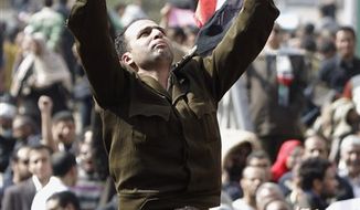 A man identified only as Fathi, wearing the uniform of a captain in the Egyptian army, is carried by demonstrators on Tahrir, or Liberation Square, in Cairo, Egypt, Monday Jan. 31, 2011. A coalition of opposition groups called for a million people to take to Cairo&#39;s streets Tuesday to demand the removal of President Hosni Mubarak, the clearest sign yet that a unified leadership was emerging for Egypt&#39;s powerful but disparate protest movement. In an apparent attempt to show change, Mubarak named a new government, but the lineup dominated by regime stalwards was greeted with scorn by protesters. (AP Photo/Ben Curtis)