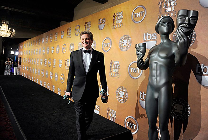 Colin Firth holds awards for best actor and ensemble for " The King's Speech" at the 17th Annual Screen Actors Guild Awards on Sunday, Jan. 30, 2011, in Los Angeles. (AP Photo/Chris Pizzello)