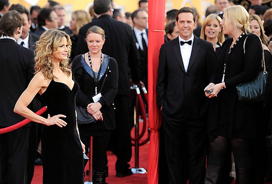 Ed Helms watches as Kyra Sedgwick arrives at the 17th Annual Screen Actors Guild Awards on Sunday, Jan. 30, 2011, in Los Angeles. (AP Photo/Chris Pizzello)