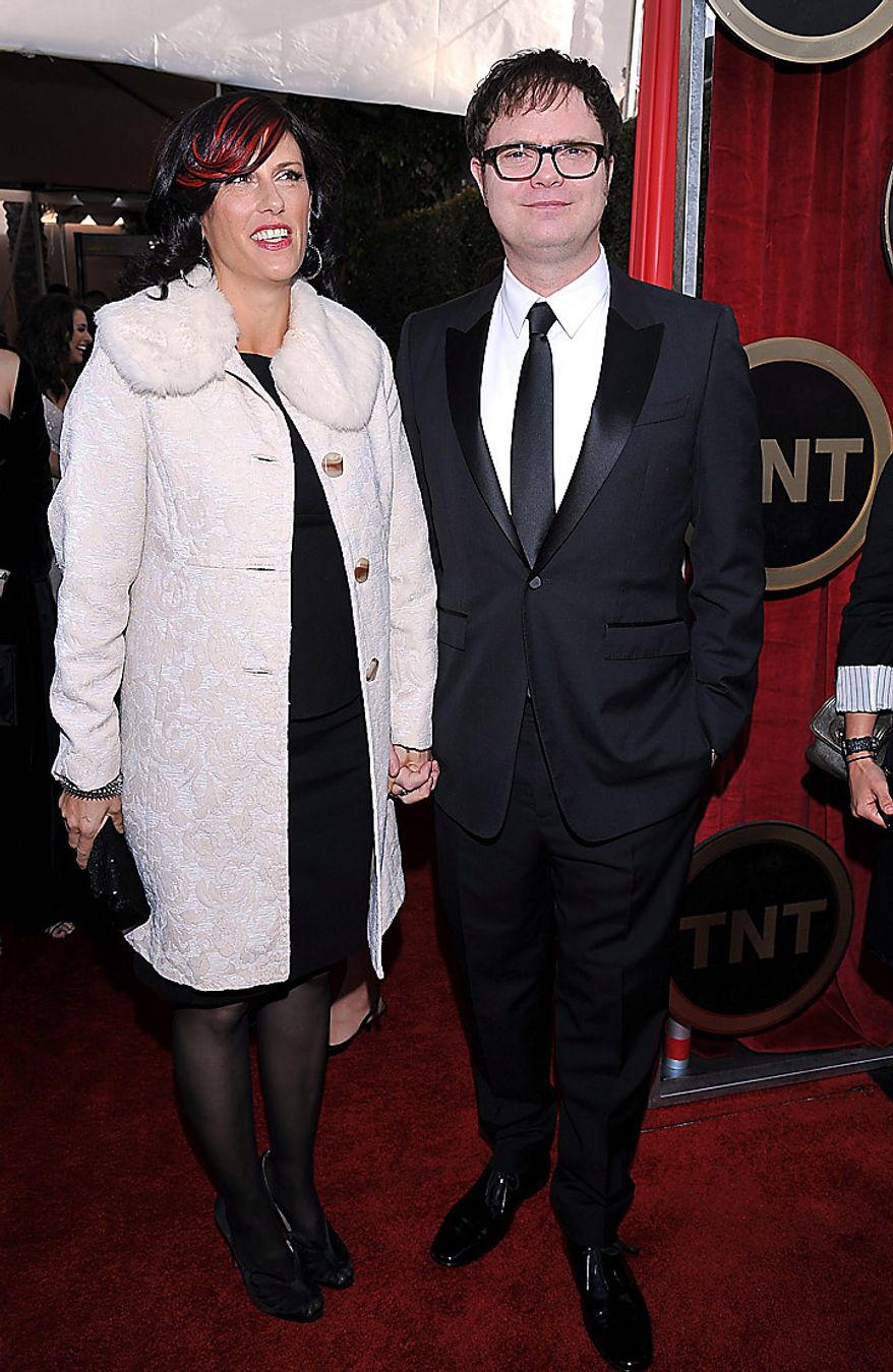 Rainn Wilson, right, and Holiday Reinhorn arrive at the 17th Annual Screen Actors Guild Awards on Sunday, Jan. 30, 2011, in Los Angeles. (AP Photo/Vince Bucci)