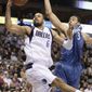 Dallas Mavericks center Tyson Chandler (6) reaches out for a rebound against Washington Wizards center JaVale McGee, right, during the first half of an NBA basketball game in Dallas on Monday, Jan. 31, 2011. (AP Photo/Mike Fuentes)
